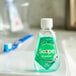A bottle of Crest Scope Classic Mint mouthwash on a white plate.