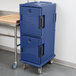 A navy blue plastic Cambro Ultra Camcart food pan carrier on wheels with black handles.