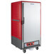 A red Metro C5 heated holding cabinet with wheels.