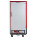 A large silver and red Metro C5 3 Series heated holding cabinet on wheels.