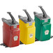 Three red, yellow, and green plastic countertop pump dispensers with grey lids.