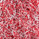 A pile of red and white Spring-Fill crinkle cut paper shred.