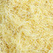 A close-up of shredded yellow paper fibers.
