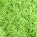 Lime green Spring-Fill paper shred. A close-up of a pile of lime green paper shred with a grass texture.