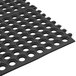 A black Cactus Mat anti-fatigue floor mat with holes.