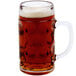 A Stolzle glass beer mug filled with beer and foam.