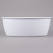 A white oval melamine casserole dish on a white surface.