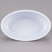 A white oval bowl on a white surface.