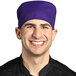 A smiling man wearing a purple Uncommon Chef skull cap.