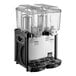 A black and silver Carnival King refrigerated beverage dispenser with clear containers.