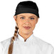 A woman wearing a black Uncommon Chef skull cap with ties.