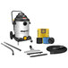 A Shop-Vac wet/dry vacuum with tools in a room.