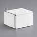 A white Lavex corrugated mailer box with a lid on a gray surface.