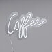 A white neon sign that says "Coffee" in cursive.