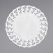 A white Hoffmaster lace doily on a gray surface.