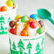 A cup of ice cream with M&M's Caramel Candies on top.
