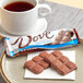 A plate with DOVE milk chocolate bars on it with a cup of tea.