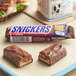 A SNICKERS® chocolate candy bar on a tray.