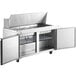 An Avantco stainless steel commercial kitchen prep table with two doors.