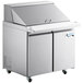 An Avantco stainless steel sandwich prep table with two doors and a cutting top.