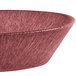 A white polyethylene oval basket with a red rim filled with raspberries.