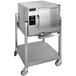 A large stainless steel AccuTemp electric steamer on wheels.