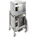 A large stainless steel AccuTemp double-stacked electric steamer on wheels.