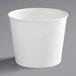 An Innopak white poly-coated paper bucket with a lid on a gray surface.