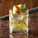 An Anchor Hocking Alistair double old fashioned glass filled with ice and orange slices.