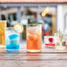 Arcoroc Essentials cooler glasses filled with colorful drinks on a table.