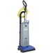 A blue and grey Clarke CarpetMaster 115 upright vacuum cleaner with a yellow hose.