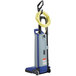 A white and blue Clarke CarpetMaster upright vacuum cleaner with a yellow hose.