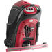 A red and black Viper walk behind floor scrubber with a handle.