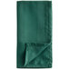 A folded Oxford forest green cloth napkin.