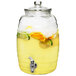 A Stylesetter glass beverage dispenser filled with lemonade and fruit slices.