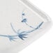A close-up of a Thunder Group Blue Bamboo rectangular melamine plate with blue bamboo leaves on it.