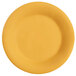 A close up of a GET Diamond Mardi Gras tropical yellow melamine plate with a wide rim.
