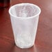 A Lavex translucent plastic cup wrapped in plastic on a table.
