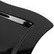 A close up of a Fineline black plastic square plate with a curved edge.