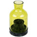 A green glass Sterno candle holder with a black base and a lit candle inside.
