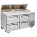 A Turbo Air stainless steel pizza prep table with drawers.