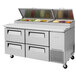 A Turbo Air stainless steel pizza prep table with drawers.