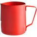 An Acopa red frothing pitcher with a handle.