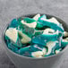 A bowl of Albanese blue gummi shark shaped candies.