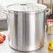 A close-up of a large silver Vollrath Wear-Ever stock pot on a counter.