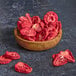 Freeze-dried strawberry slices in a wooden bowl.