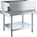 A Cooking Performance Group stainless steel countertop range with a Regency Equipment stand.
