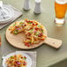 An Acopa faux wood melamine serving board with a plate of fries, cheese, and jalapenos on it.