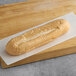 A long loaf of Turano French bread on a cutting board.