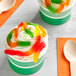 Two cups of ice cream with Kervan Gummy Worms on top.